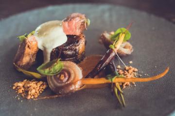 Massaman Neua - Braised of local oxtail, grilled Thai flank, potato espuma, char onions, confit garlic, massaman curry