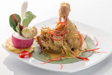 Chicken leg marinated with Thai herbs, served with red curry