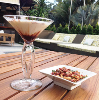 An exotic cocktail & snack in the outdoor seating area